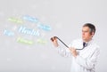 Clinical doctor pointing to health and fitness collection of words