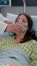 Clinical team monitoring patient putting oxigen mask analyzing respiratory condition