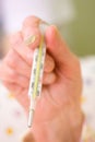 Clinical thermometer in elderly hands Royalty Free Stock Photo