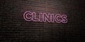 CLINICS -Realistic Neon Sign on Brick Wall background - 3D rendered royalty free stock image