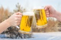 Clinking Beer glasses on winter. Royalty Free Stock Photo