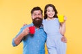 Clinking cups. Water balance and health care. Family drinking tea. Bearded man and happy girl holding mugs. Father and Royalty Free Stock Photo