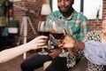 Clinking glasses of red wine at apartment party Royalty Free Stock Photo