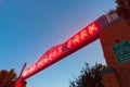 Art deco McLain Rogers Park sign illuminated bright red at night