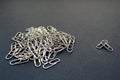 Metallic paper clips silver color black background Royalty Free Stock Photo