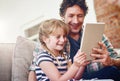 This clip always gives her the giggles. a father and his little daughter using a digital tablet at home.