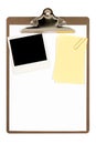 Clipboard with polaroid photo frame and yellow post-it style sticky note, isolated on white background, copy space Royalty Free Stock Photo