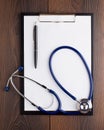 Clipboard with blank paper, pen and stethoscope Royalty Free Stock Photo