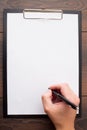 Clipboard with blank sheet of white paper and pen Royalty Free Stock Photo