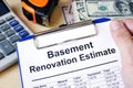 Clipboard with calculations basement renovation estimate. Remode Royalty Free Stock Photo