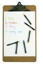 Clipboard with a childs to-do list and crayons Royalty Free Stock Photo