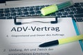 Clipboard with a contract and inscription in german ADV-Vertrag in english ADV contract and subject matter and duration of the con