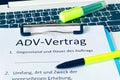 Clipboard with a contract and inscription in german ADV-Vertrag in english ADV contract and subject matter and duration of the con