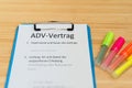 Clipboard with a contract and inscription in german ADV-Vertrag in english ADV contract and subject matter and duration of the con