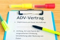 Clipboard with a contract and inscription in german ADV-Vertrag in english ADV contract and subject matter and duration of the con