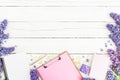 Clipboard, diary, lilac flowers and accessories on white wooden background Royalty Free Stock Photo