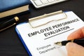 Clipboard with employee performance evaluation. Royalty Free Stock Photo