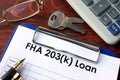 Clipboard with FHA 203k loan form.