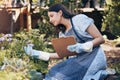 Clipboard, gardening and woman checking flowers for botany, growth or development in nature. Botanist, sustainable and