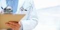 Clipboard, hands and man doctor at hospital for planning, schedule or surgery checklist closeup. Healthcare, compliance Royalty Free Stock Photo