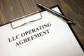 Clipboard with llc operating agreement and pen on desk Royalty Free Stock Photo