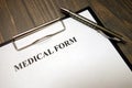 Clipboard with medical form and pen on desk Royalty Free Stock Photo