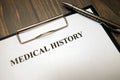Clipboard with medical history and pen on desk Royalty Free Stock Photo