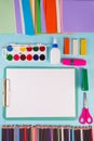 Clipboard and office or school supplies over blue background, flat lay. Back to school Royalty Free Stock Photo