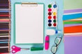 Clipboard and office or school supplies over blue background, flat lay. Back to school Royalty Free Stock Photo