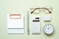 Clipboard, pen, clock, eyeglasses, calculator, eraser on mint desk background. study and workspace. flat lay, top view, copy space Royalty Free Stock Photo