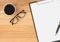 Clipboard with pen ,eyeglasses and coffee cup on vintage brown w Royalty Free Stock Photo