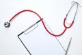 clipboard with red stethoscope and pen Royalty Free Stock Photo