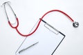 clipboard with red stethoscope and pen Royalty Free Stock Photo