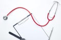 clipboard with red stethoscope and pen Royalty Free Stock Photo