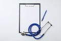 Clipboard with space for text, pen and stethoscope on white background, top view. Royalty Free Stock Photo