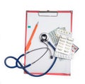 Clipboard with stethoscope, pen, dollar, money and drag pills Royalty Free Stock Photo