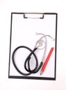 Clipboard, stethoscope and red pen Royalty Free Stock Photo