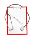 Clipboard with stethoscope and syringe Royalty Free Stock Photo