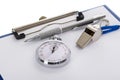 Clipboard with whistle; pen; paper and stopwatch Royalty Free Stock Photo