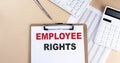Clipboard with white blank paper text EMPLOYEE RIGHTS , keyboard calculator and chart, top view. business concept Royalty Free Stock Photo
