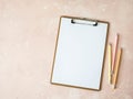 Clipboard with white sheet paper copy space for text and multicolored graphite pencils on pink background. Flat lay, top view girl Royalty Free Stock Photo