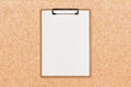 Clipboard with white sheet and space for text on craft paper background