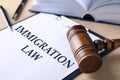 Clipboard with words IMMIGRATION LAW and gavel on table, closeup Royalty Free Stock Photo