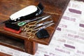 Clippers and many scissors placed on the wooden table Royalty Free Stock Photo