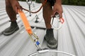 Clipping industrial hook connected with fall arrest shock absorbing safety lanyard device into horizontal lifeline