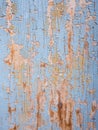 Cloaeup of light blue and ocher peeling paint on old wood