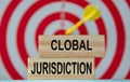 CLOBAL JURISDICTION - an word on wooden blocks against the background of a dartboard