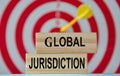 CLOBAL JURISDICTION - an word on wooden blocks against the background of a dartboard