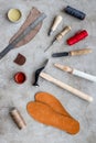 Clobber preparing his tools for work. Grey stone desk background top view