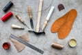 Clobber preparing his tools for work. Grey stone desk background top view